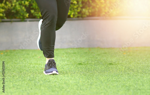 woman wearing sports shoes jogging run in the lawn