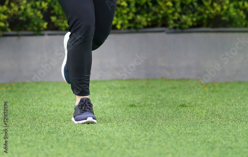 woman wearing sports shoes jogging run in the lawn