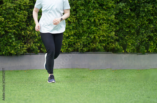 woman wearing sports shoes jogging run in the lawn