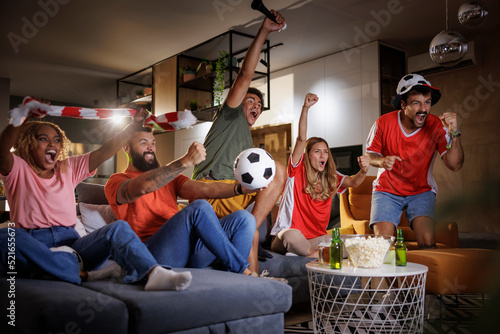 Friends watching football celebrating their team victory photo