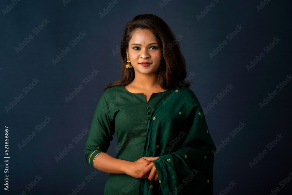 Portrait of a young girl or woman posing on gray background Portrait of a young girl or woman posing on gray background