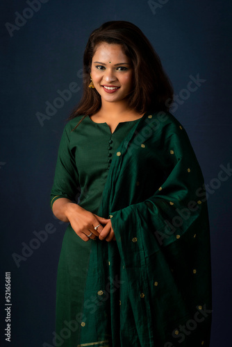 Portrait of a young girl or woman posing on gray background