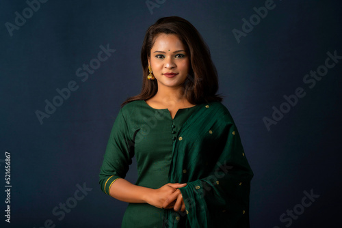 Portrait of a young girl or woman posing on gray background