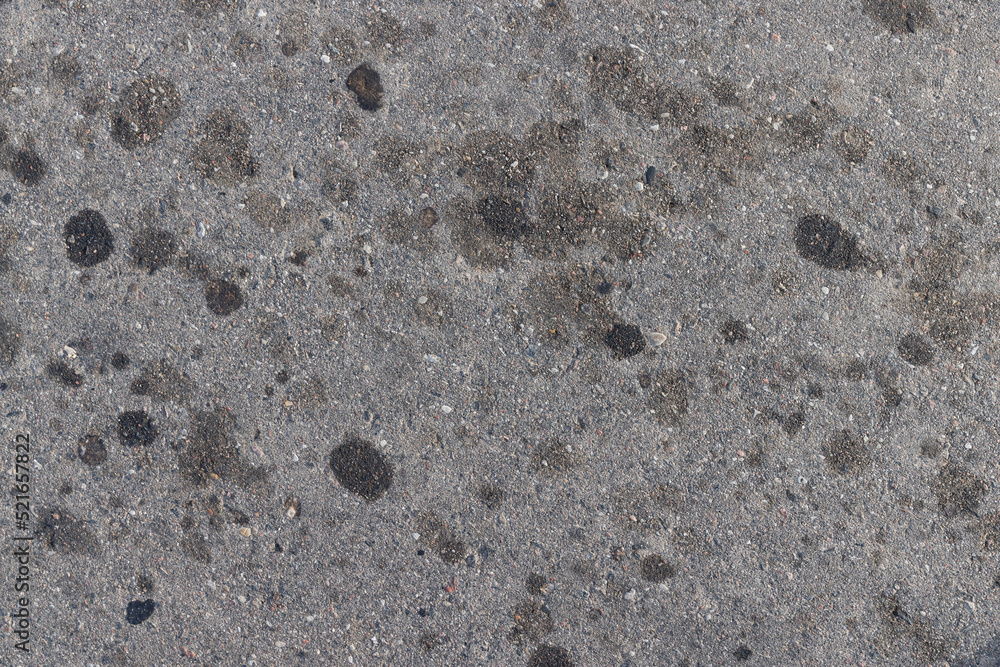 Fototapeta premium A road for vehicles covered with stains and pollution from oil and fuel of cars