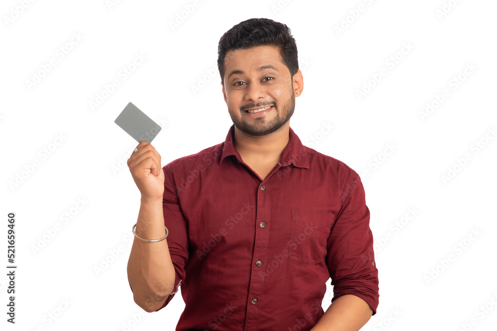 Young smiling handsome man posing with a credit or debit card on white background. Young smiling handsome man posing with a credit or debit card on white background.