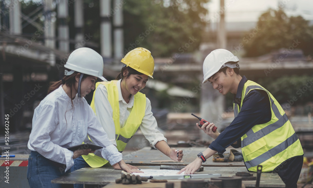Asian woman civil engineer paper plan building architect wearing white safety helmet look at contruction site.Female foreman in a construction helmet, facemask, Asian woman civil engineer paper plan building architect wearing white safety helmet look at contruction site.Female foreman in a construction helmet, facemask,