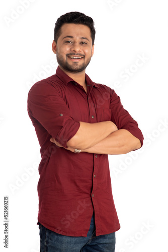 Portrait of a happy young man posing with arms crossed or hands folded on a white background © Dip Photography