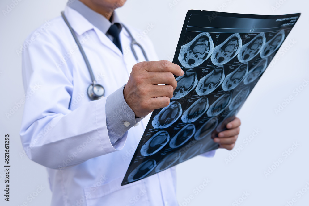 Orthopedic surgeon doctor examining patient's knee joint xray films