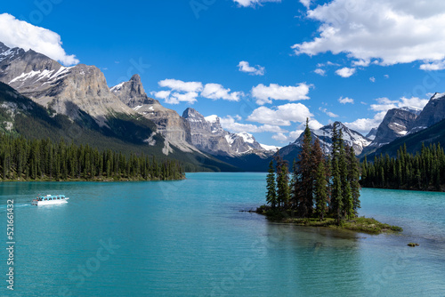 A boat cruise departs from Spirit Island on Maligne Lake in Jasper National Park on a sunny day