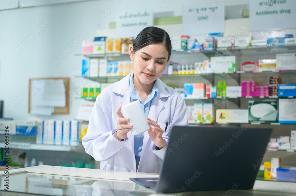 Female pharmacist counseling customer via video call in a modern pharmacy drugstore.