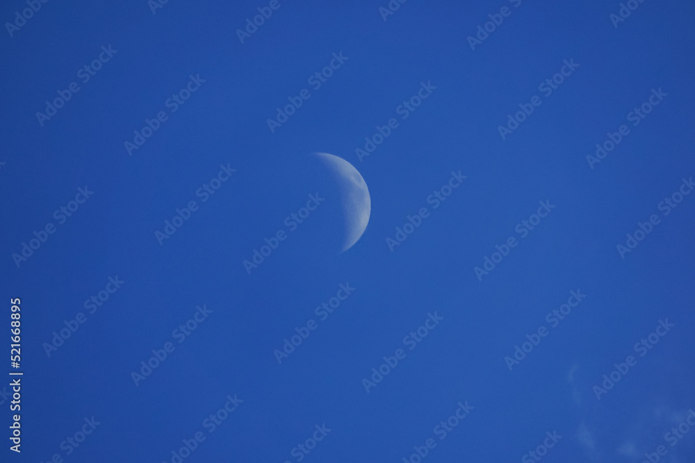 Crescent moon with blue sky for background.