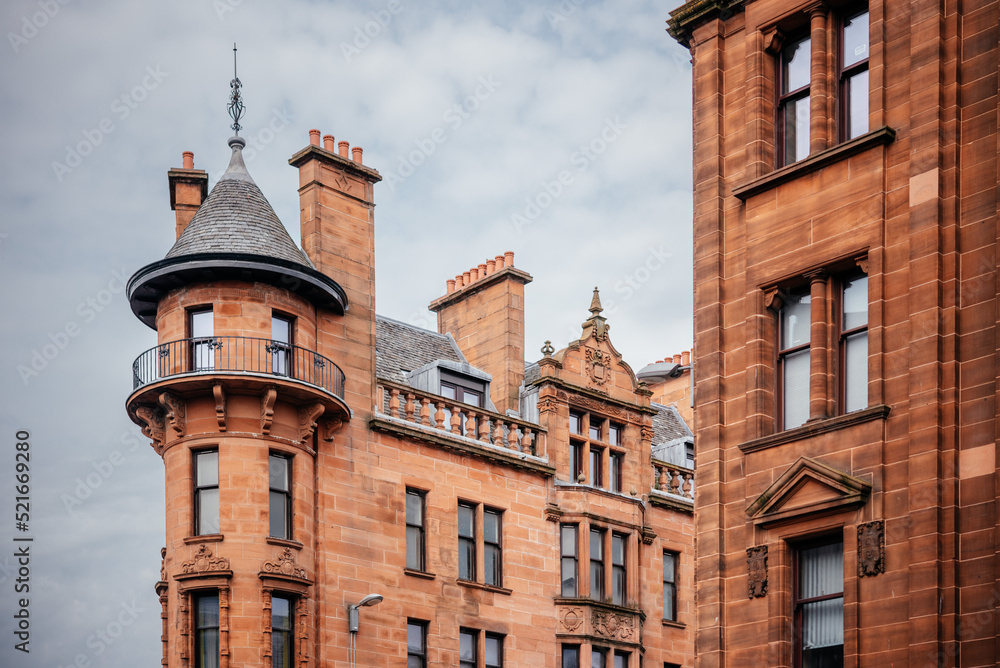 Historic buildings with towers built with red stone in Glasgow, Scotland