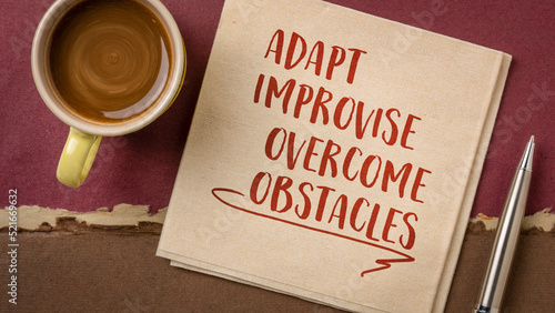 adapt, improvise, overcome obstacles - motivational note or advice on a napkin, challenge and personal development concept