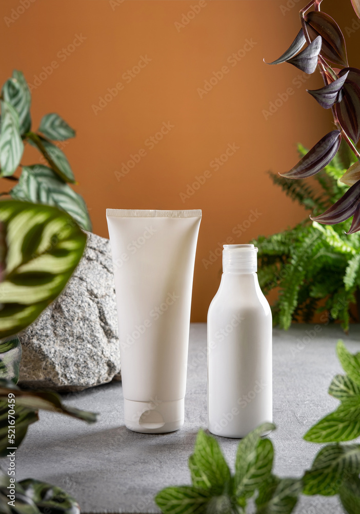 Сosmetic product branding with tropical leaves on tan color background. Cosmetic product ad with natural cosmetics ingredients for skincare and body Сosmetic product branding with tropical leaves on tan color background. Cosmetic product ad with natural cosmetics ingredients for skincare and body