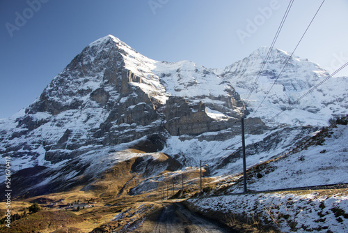 Snow covered Eiger in autumn with the Wengernalpbahn railtrack in the foreground photo