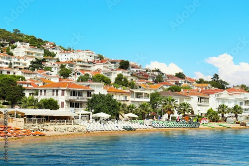 Deserted sandy beaches with sun loungers, snow-white houses descend the slope to the seashore