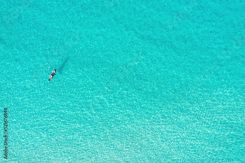 Summer vacation fun  sport activity. Men on Canoe kayak in turquoise blue Aegean Sea  aerial view.