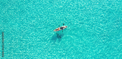 Summer vacation fun, sport activity. Men on Canoe kayak in turquoise blue Aegean Sea, aerial view. © Rawf8