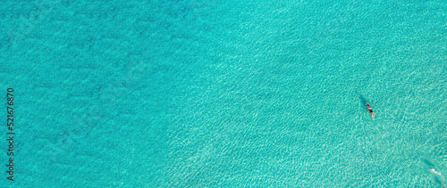 Summer vacation fun, swim and canoe kayak in turquoise blue Aegean Sea, aerial drone top view.