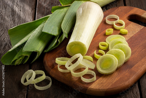 Sliced ​​leek on wooden table. photo