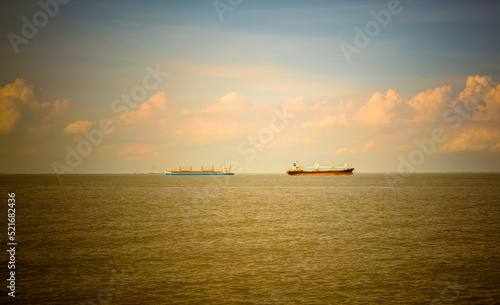 Wallpaper Mural cargo ship at sunset on the sea Torontodigital.ca