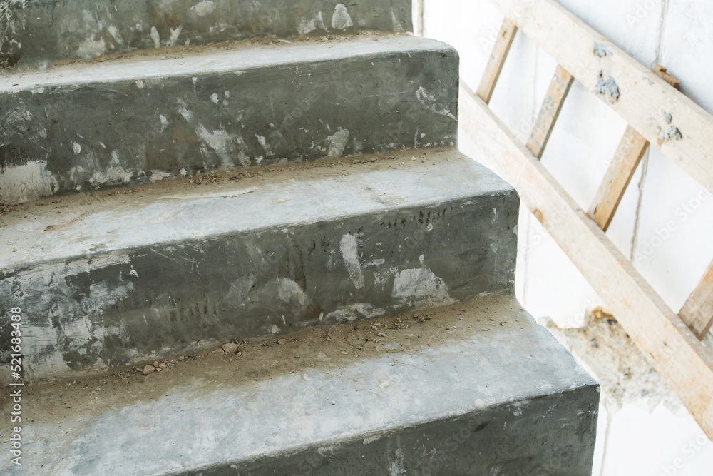 Fragment of concrete steps in a house under construction. Close-up Fragment of concrete steps in a house under construction. Close-up