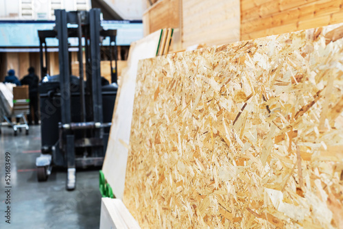 OSB sheets on the counter in a hardware store. Trade in materials from chips and glue. Panels for facing various surfaces and construction of various structures. Selective focus. Foreground photo