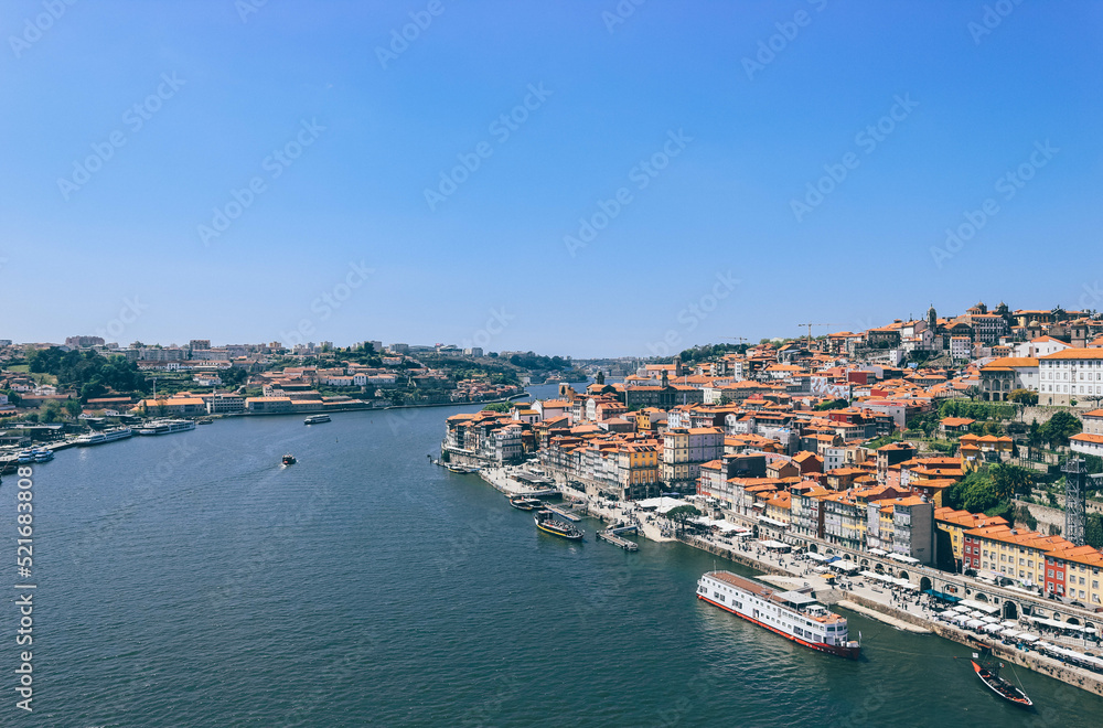 View of Duoro bay of Oporto city from top with boats navigating 