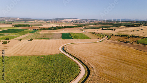 Farm fields, mountain and sky. Drone view of farmland. Ecological life and soil.