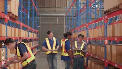 Professional, team group asian male warehouse worker working in warehouse of shelf. While manager or supervisor walking and checking discuss with staff in Factory or Distribution logistics center.