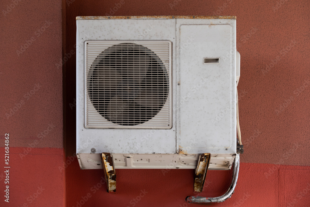 old outdoor air conditioner unit hanging outside the building old outdoor air conditioner unit hanging outside the building