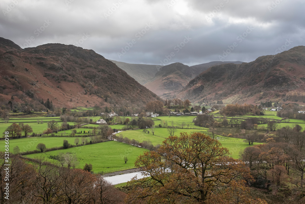 Beautiful vibrant Autumn landscape image towards Borrowdale Valley from Castle Crag in Lake Disrtrict