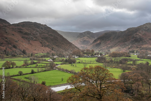 Beautiful vibrant Autumn landscape image towards Borrowdale Valley from Castle Crag in Lake Disrtrict