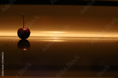 A red cherry in low light.