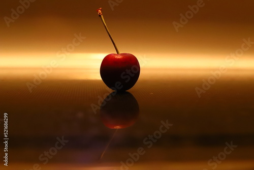 A red cherry in low light.