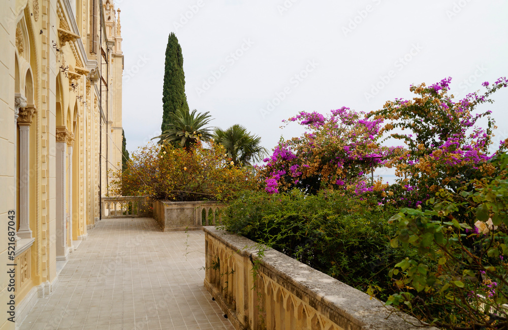 gorgeous mediterranean garden full of tropical trees and exotic pink flowers on Isola del Garda or Isola di Garda or Isola Borghese on lake Garda, Italy