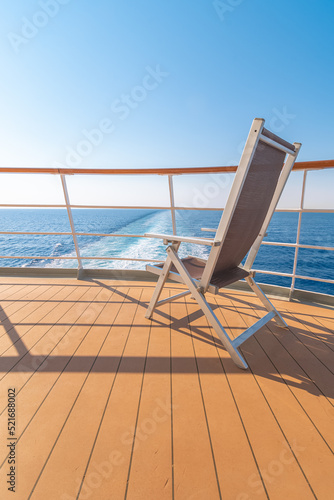 Vue d'une chaise longue sur le pont d'un navire de croisière dans le sillage d'un navire de croisière. Vue depuis la poupe du navire. 