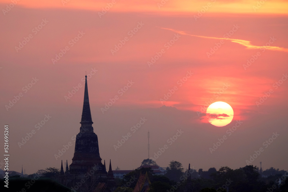 Silhouette Buddhism pagoda on dramatic sky background during sunset