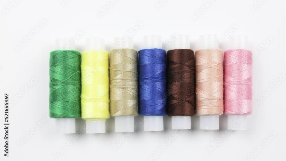 Multi-colored threads on a white background.The concept of sewing, tailor. Multi-colored threads on a white background.The concept of sewing, tailor.