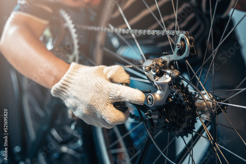 Close up repairman mechanic working in bicycle repair shop with bike tools and part, bike maintenance at bike shop, self bike service at home.
