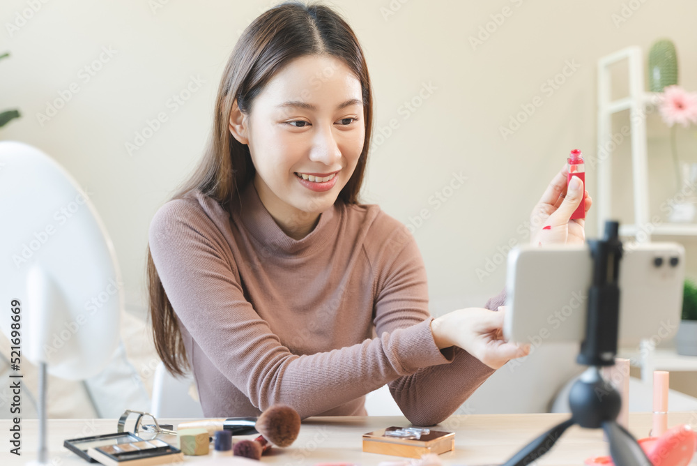 asian female beauty social media influencer livestream marketing cosmetics a make up tutorial via smartphone. asian female beauty social media influencer livestream marketing cosmetics a make up tutorial via smartphone.