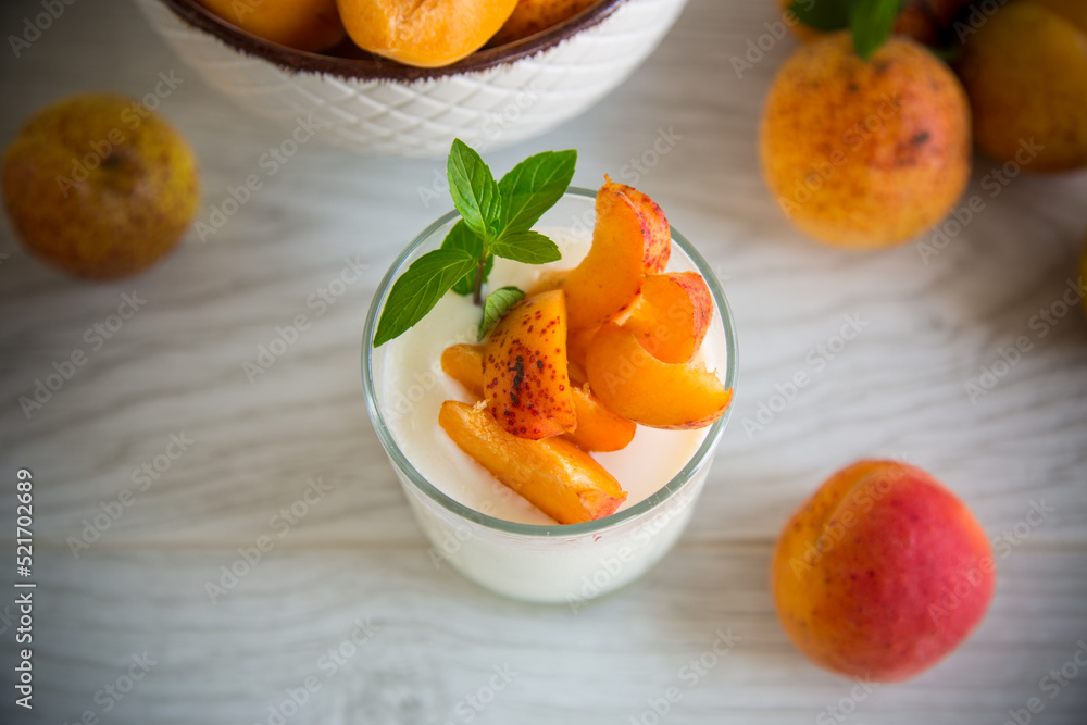 Healthy breakfast of homemade yogurt in a glass with fresh apricots