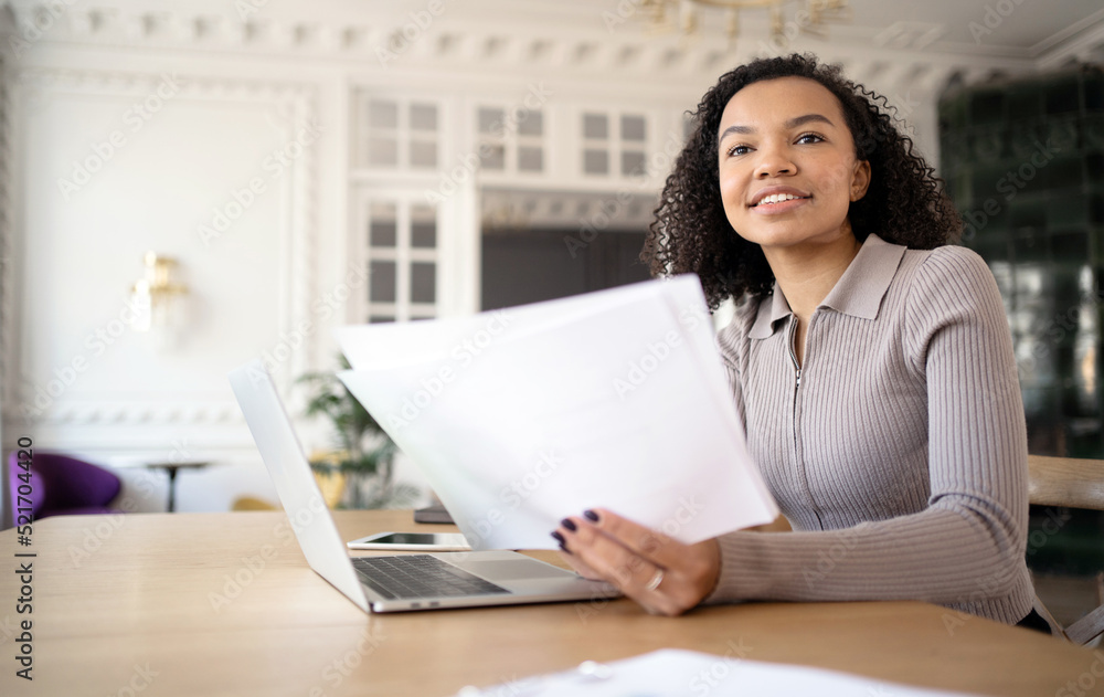 A woman in the office works with documents, responds to the client A woman in the office works with documents, responds to the client