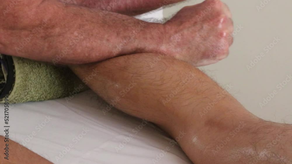 Young male adult having a sports massage Young male adult having a sports massage