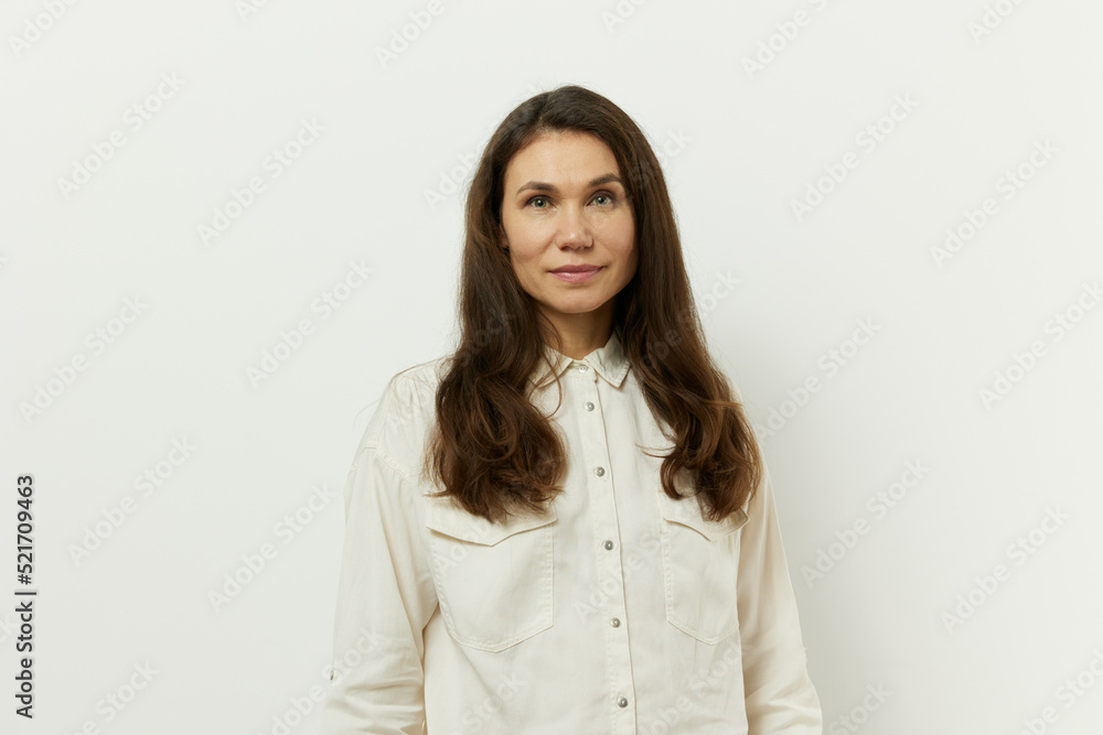 portrait of a beautiful happy attractive adult woman in a white shirt on a white background