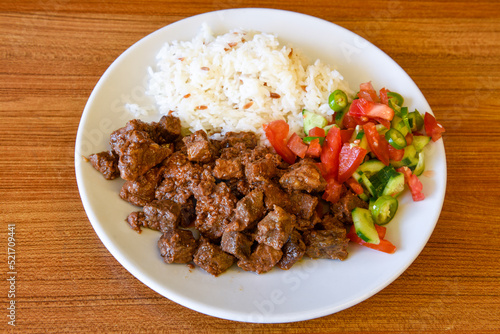 Beef steak grill with rice pilaf, fried potatoes, grilled pepper and tomatoes.Mix Platter with Beef rips, Cutlets, Potatoes and Sauces.