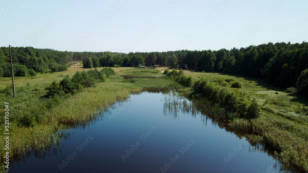 Rural landscape. Green forests and natural reservoir. Aerial photography.
