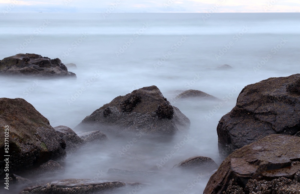 Waves crashing on rocks in a long exposure shot