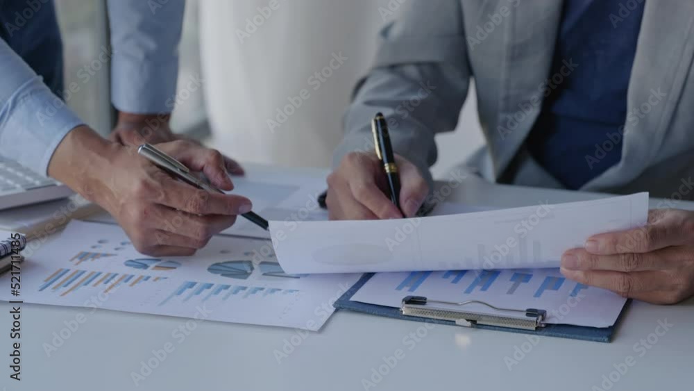 Close up of business person are discussed and brainstorming on paperwork that show accounting numbers tables on office space. Close up of business person are discussed and brainstorming on paperwork that show accounting numbers tables on office space.