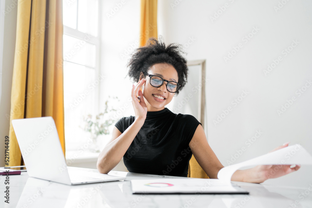 A young woman with glasses is an online designer working in an office in a coworking space A young woman with glasses is an online designer working in an office in a coworking space